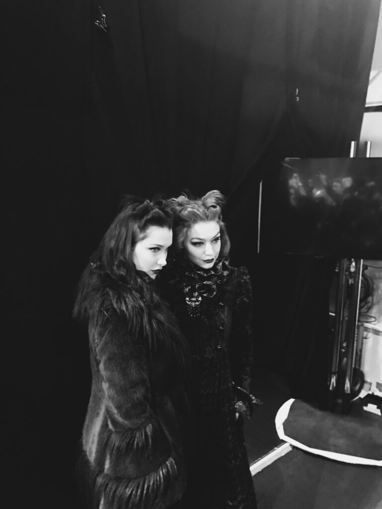 Bella Hadid and Gigi Hadid backstage in editorial black and white