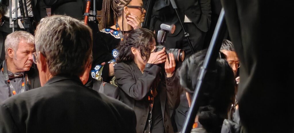 Photographer working on the Cannes Film Festival 2026 press line among media professionals