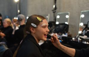 The Faces Fashion Can’t Look Away From: 2026’s Most Influential Models Gigi Hadid preparing backstage before a Prada runway show