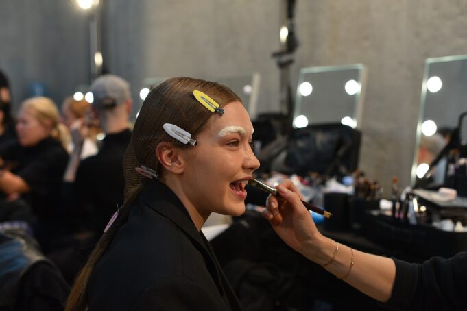 Gigi Hadid preparing backstage before a Prada runway show