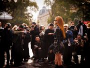 Women’s Paris Fashion Week 2026: The Dates, Shows & Secrets Worth Knowing Elegant guest arriving amid photographers at Women's Paris Fashion Week