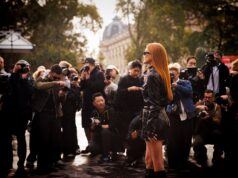 Women’s Paris Fashion Week 2026: The Dates, Shows & Secrets Worth Knowing Elegant guest arriving amid photographers at Women's Paris Fashion Week