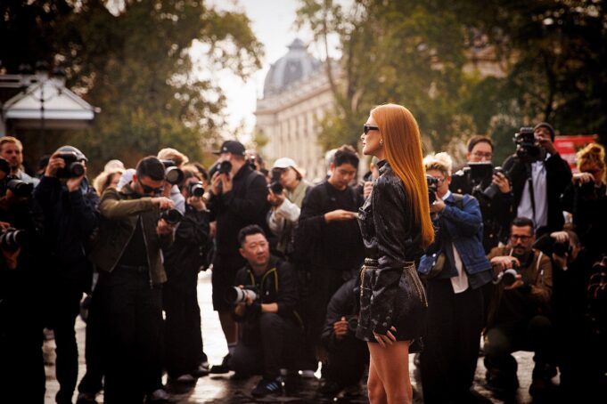 Paris Fashion Week Arrival in a Crowd of Photographers Elegant guest arriving amid photographers at Women's Paris Fashion Week