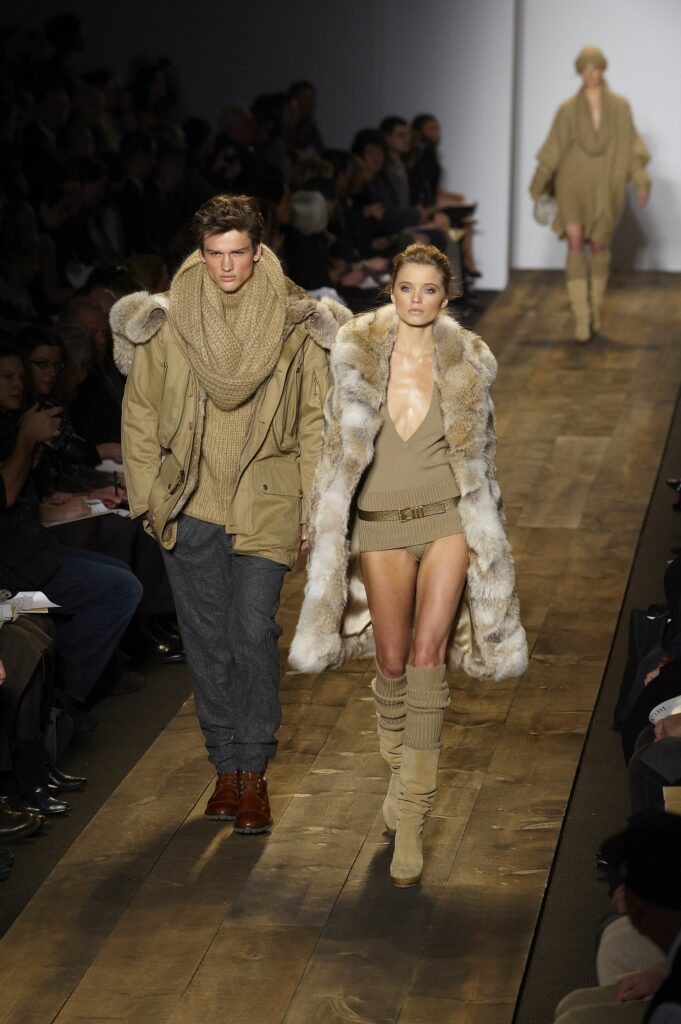 Male and female models walking a Michael Kors runway in New York