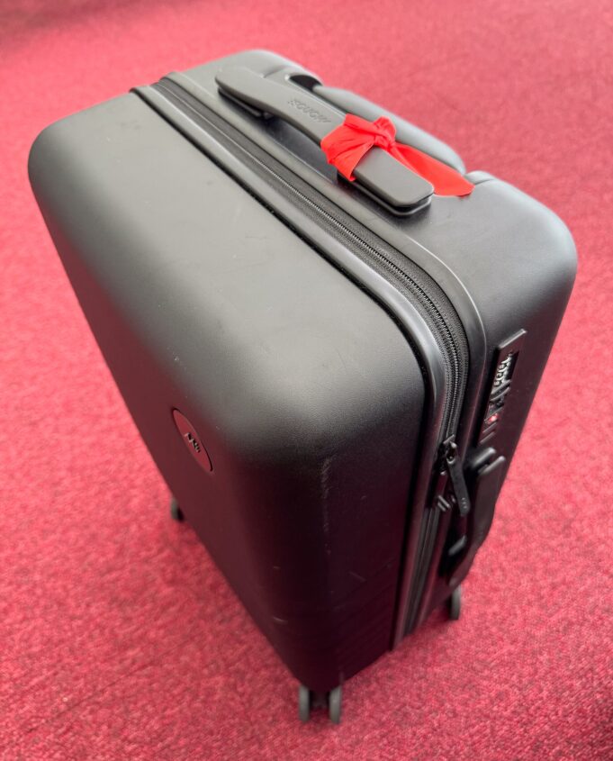 Traveller with wheeled luggage at an airport before the bag enters the handling system