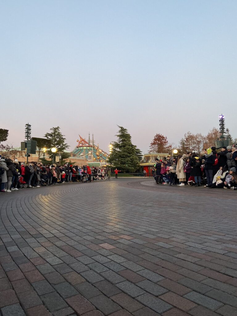 Visitors gathering along the parade route during a winter day at Disneyland Paris