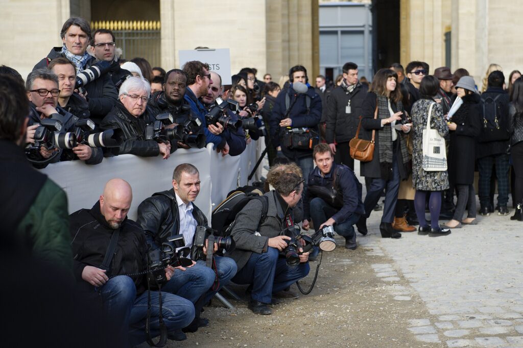Press photographers waiting outside a Louis Vuitton Paris Fashion Week show