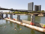 10 Free Things to Do in Paris This Summer (2026): Swim in the Seine, Open-Air Cinema & Hidden Experiences Swimmers at the Bercy Seine bathing site with the Bibliothèque nationale de France in view