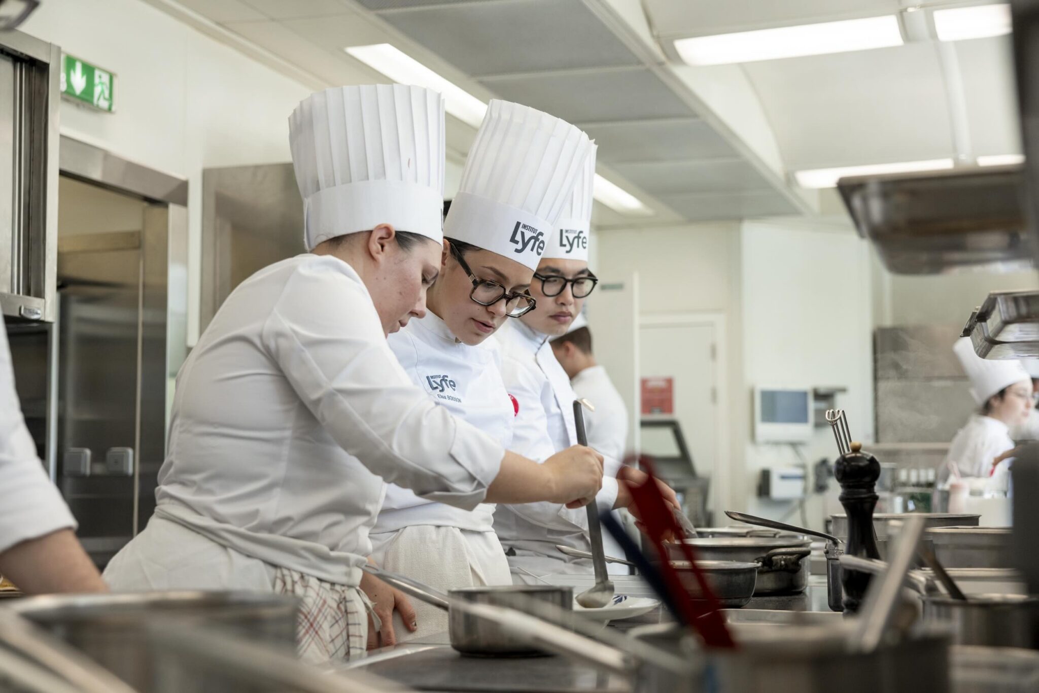 Institut Lyfe culinary arts students training in a professional teaching kitchen