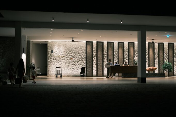 Hospitality Professionals at a Luxury Hotel Reception Hospitality professionals welcoming guests at a luxury hotel reception desk