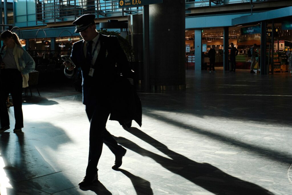 Business traveller preparing for a private Paris airport transfer in a modern terminal