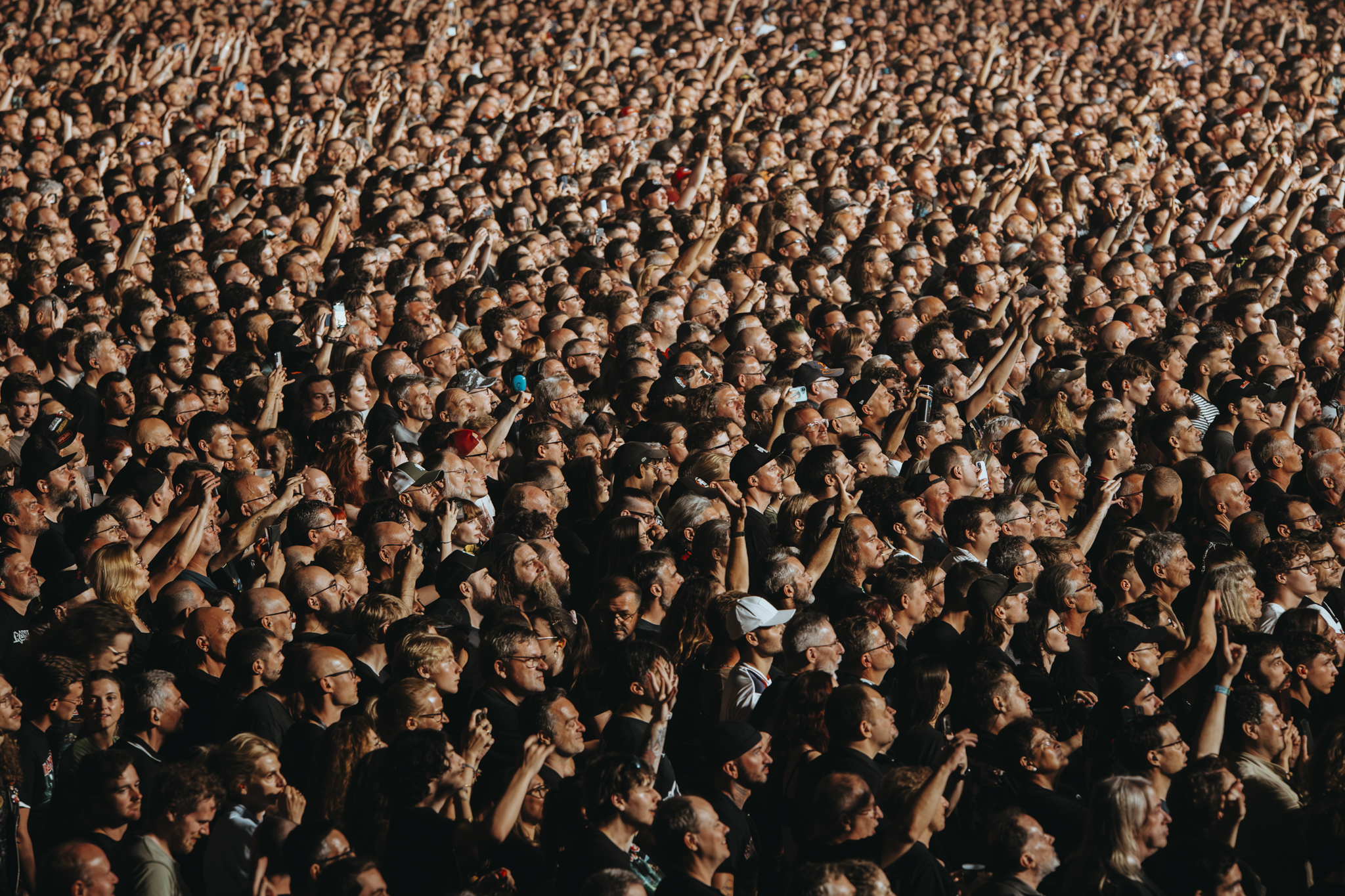 Large concert crowd filling the floor and stands inside Plenitude Arena near Paris