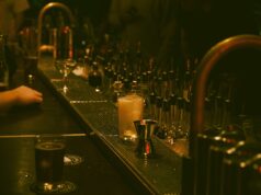 Speakeasy Bars in Paris: Hidden Doors, Secret Drinks, and Underground Vibes Bartender preparing cocktails in a dark intimate speakeasy-style bar