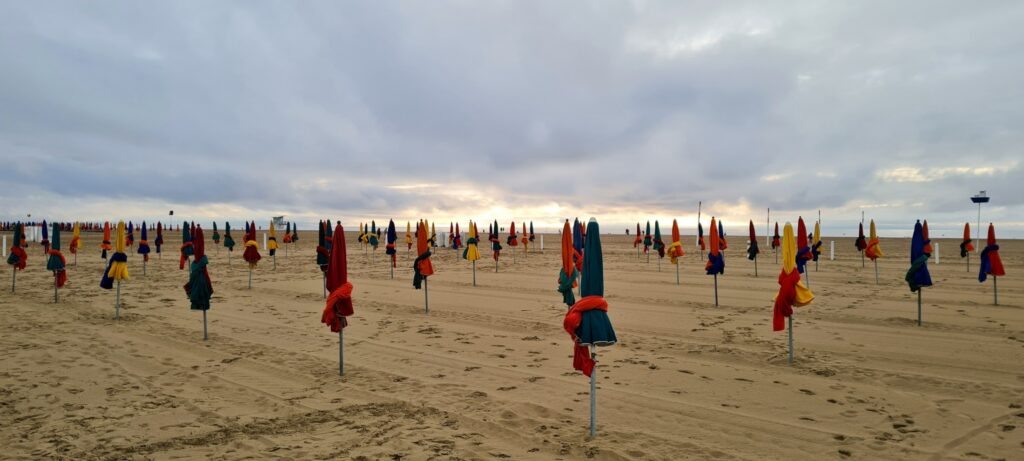 Deauville beach and its colourful parasols on a private Normandy day trip