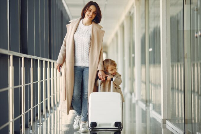CDG to Disneyland Paris with children: mother and child with luggage at an airport