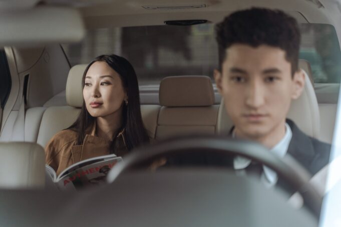 France luxury tourism — airport chauffeur experience High-spending international traveller riding with a professional chauffeur in a premium car in France