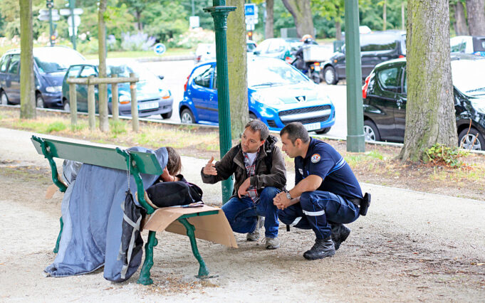 Paris Social Outreach Team Paris municipal outreach workers speaking with a person without shelter during a street support visit.