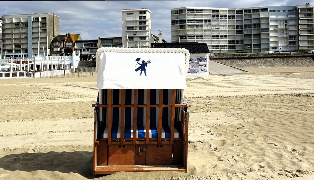 Traditional beach basket facing the sand and seafront buildings at Le Touquet on the Côte d'Opale