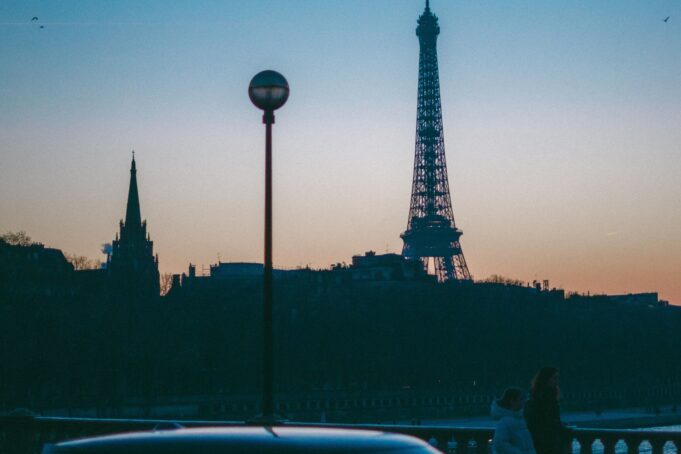 Paris at night — Eiffel Tower blue hour Eiffel Tower silhouette at blue hour as visitors begin an evening in Paris