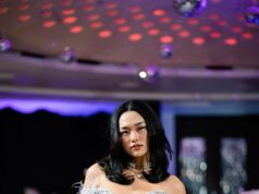 Paris Fashion Week 2026: The Designers, Celebrities and Front-Row Power Taking Over the City Glamorous fashion model in an elegant feathered dress walking a runway before an audience