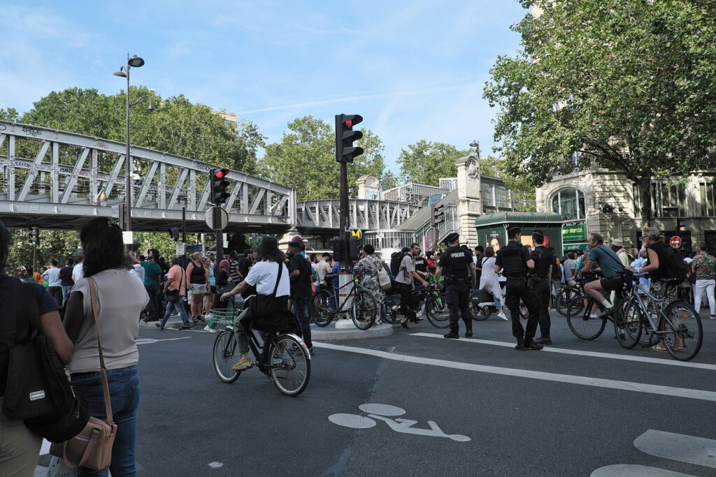 Travellers and French police near La Chapelle Métro during a crowded Paris event in 2024