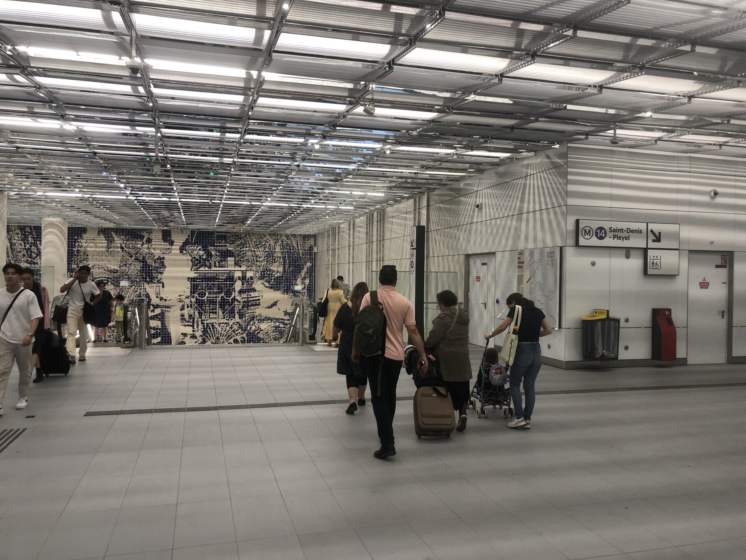 Family with luggage entering Paris Orly Airport Metro Line 14 in 2024
