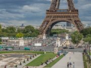 Can Paris Stay the World’s Tourism Capital Without Becoming Unliveable? The Eiffel Tower rising above dense visitor crowds in Paris in 2025