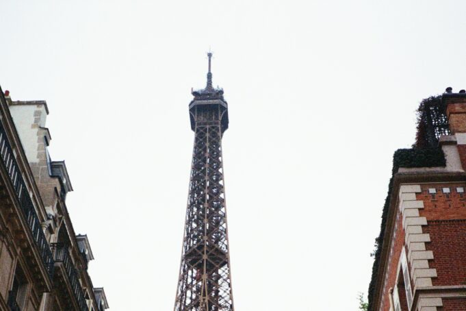 OUISTARS hero — The Eiffel Tower rising above a Paris street in 2025 The Eiffel Tower rising above a Paris street in 2025