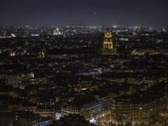 Where Should You Stay in Paris in 2026? The Neighborhood Decision That Can Make or Break Your Trip Night panorama across Paris neighborhoods from the Eiffel Tower, with Les Invalides illuminated