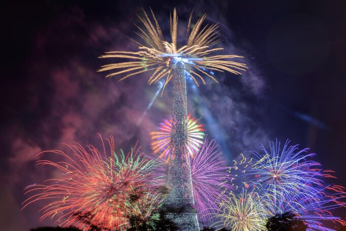 Paris events beneath the Eiffel Tower fireworks Fireworks exploding around the Eiffel Tower during the Bastille Day celebration in Paris