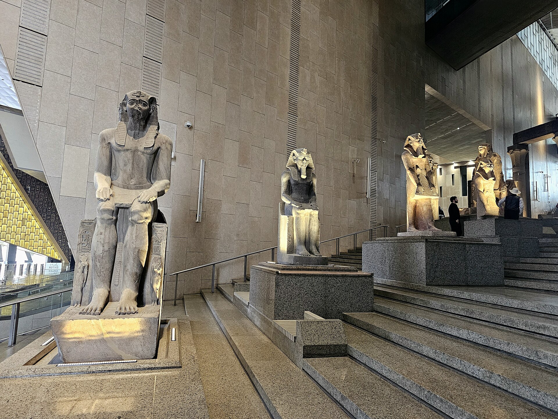 Monumental royal sculptures displayed on the Grand Staircase of the Grand Egyptian Museum