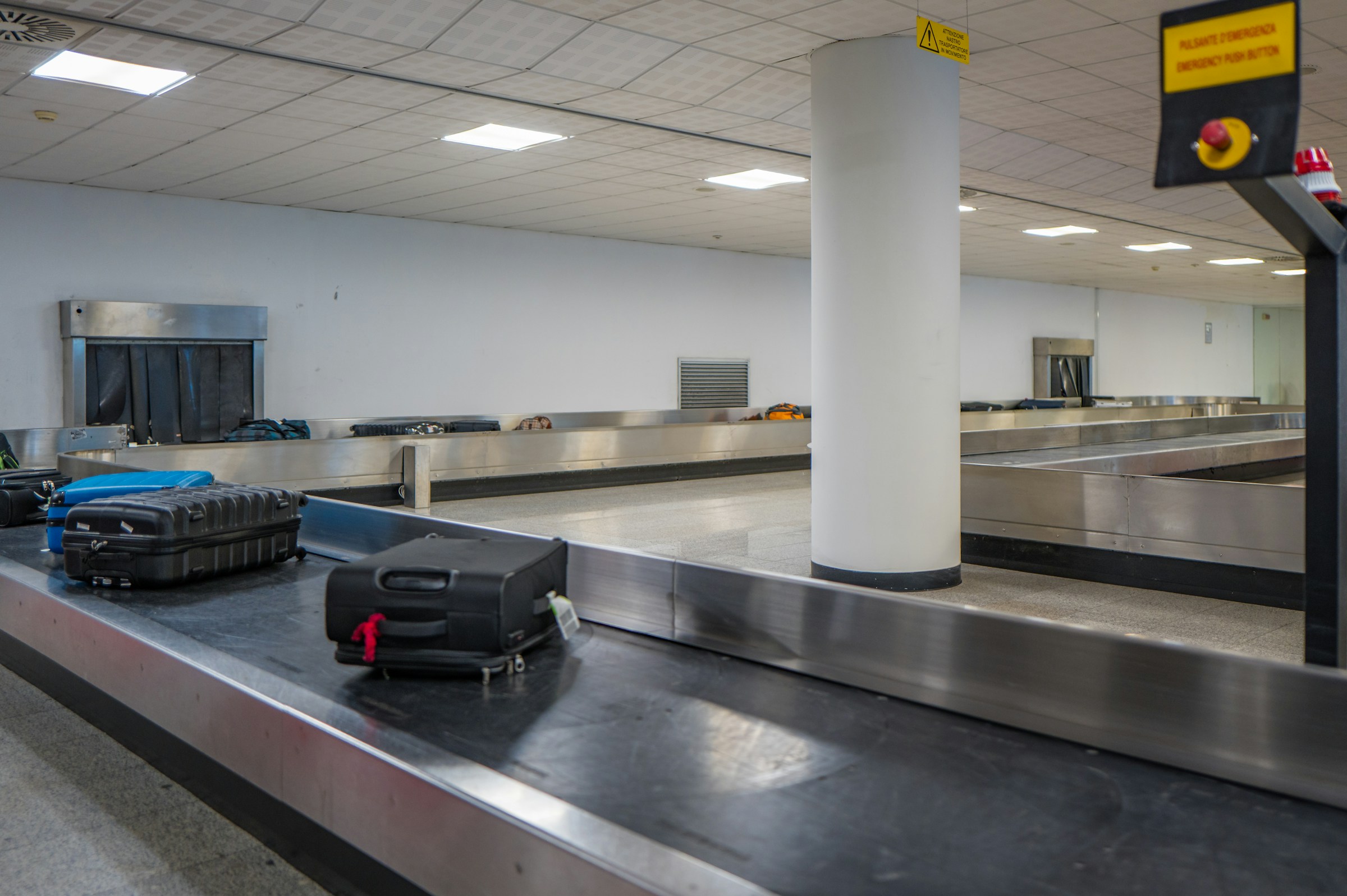 Suitcases moving along an airport baggage carousel