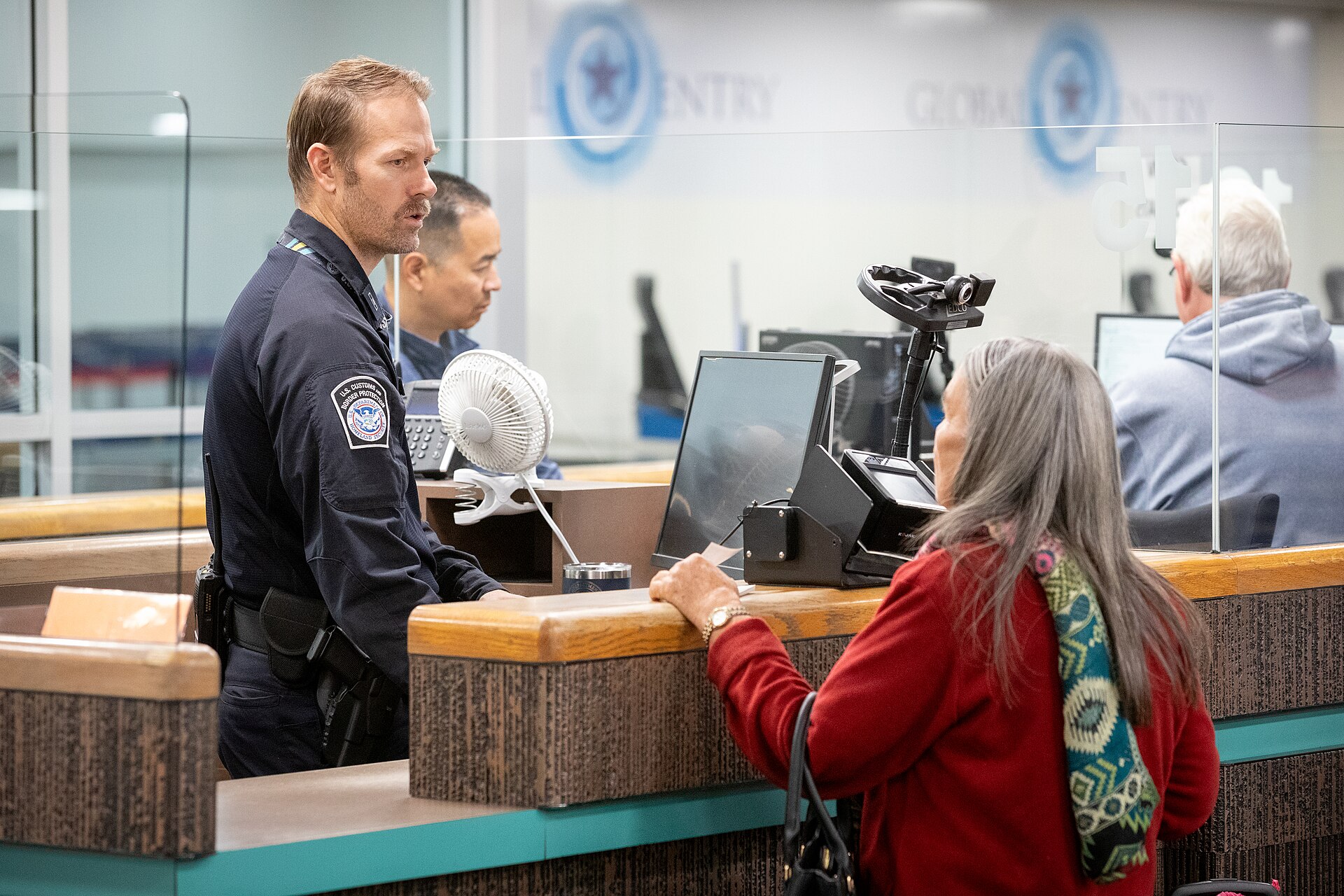 Airport officers working in an international baggage area