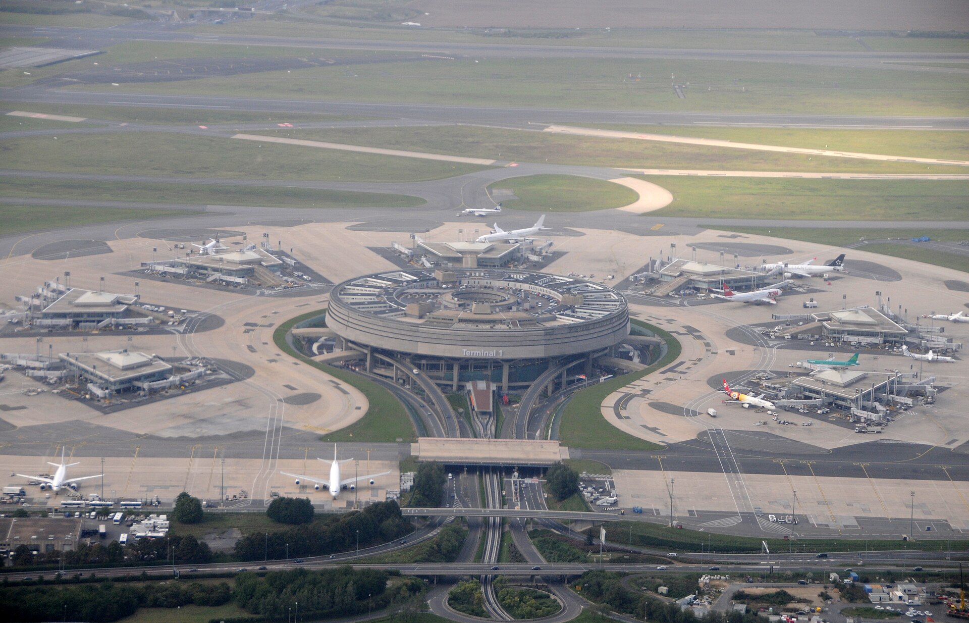 Real aerial view of the circular Terminal 1 and its satellite buildings at Paris CDG