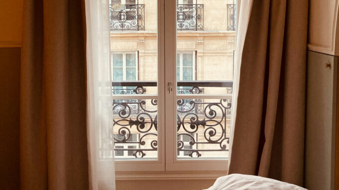 Quiet premium hotel bedroom with a large bed and a city view designed for restful sleep