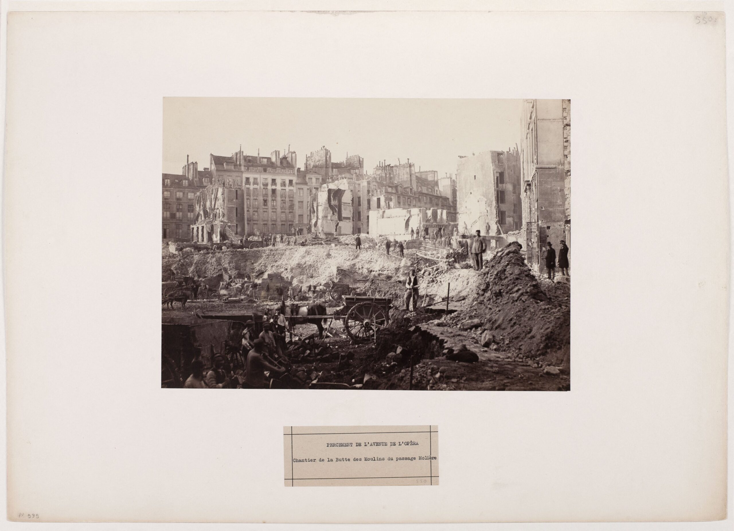 Workers, carts and demolished buildings at the Avenue de l’Opéra construction site in 1876