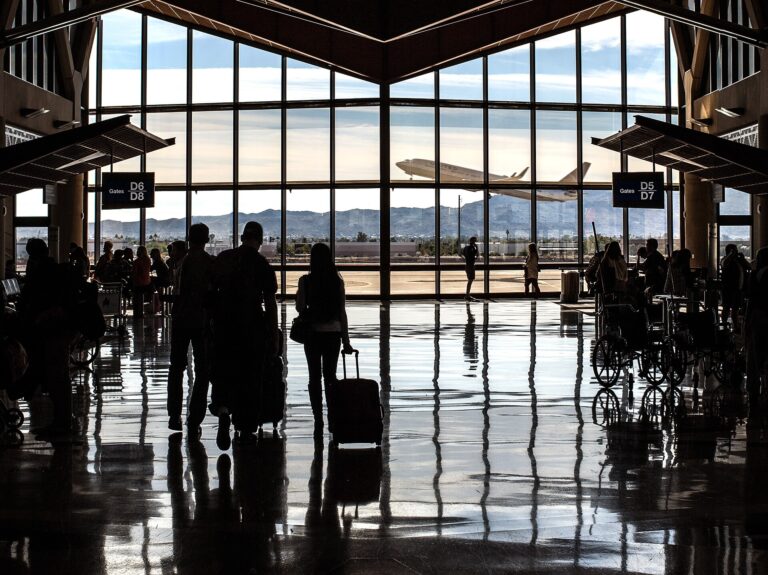 Real photograph of passengers of different backgrounds moving through an airport terminal