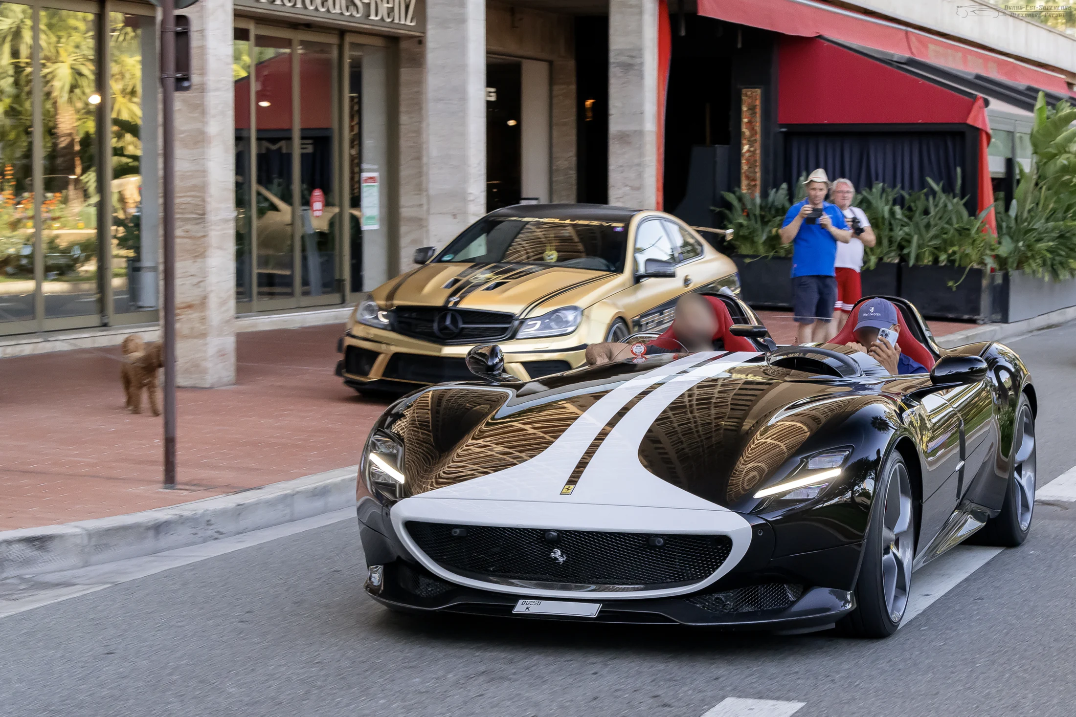 Ferrari Monza SP2 and another luxury car driving on a Monaco street