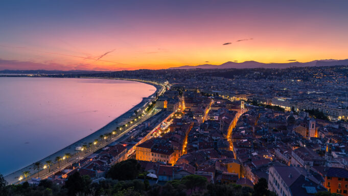 Nice property and year-round tourism on the Baie des Anges Panoramic sunset view over Nice, the Baie des Anges, Promenade des Anglais and residential districts