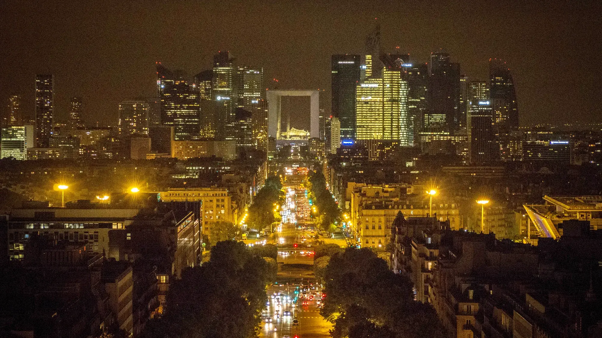 Illuminated La Défense business skyline seen from the Arc de Triomphe at night