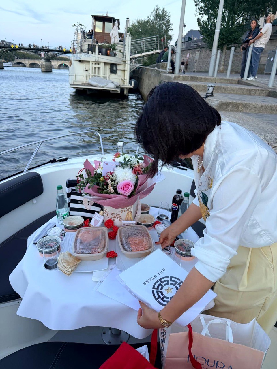 Preparing a private table on a boat in Paris