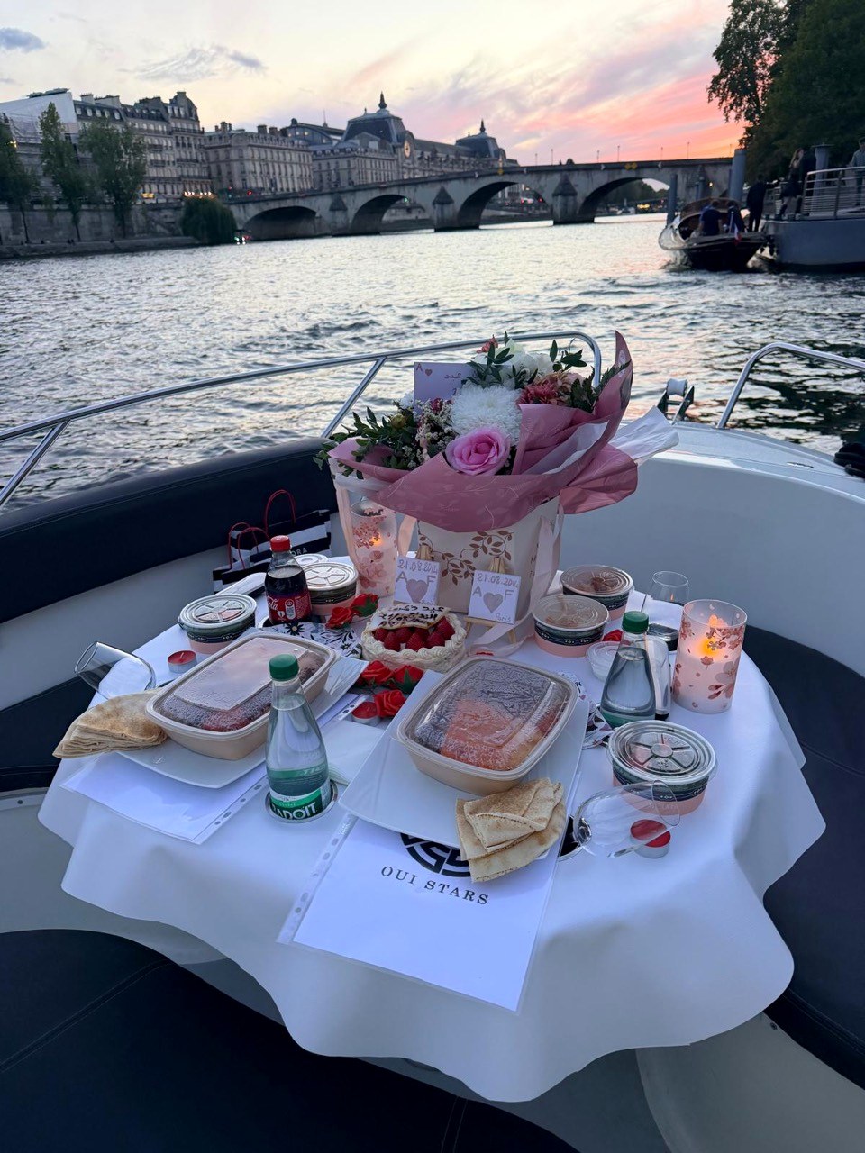Dinner table and flowers on a Seine boat at sunset