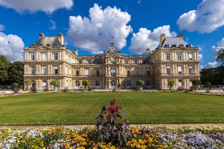 Luxembourg Palace, home of the French Senate, beneath a dramatic summer sky in Paris in 2026