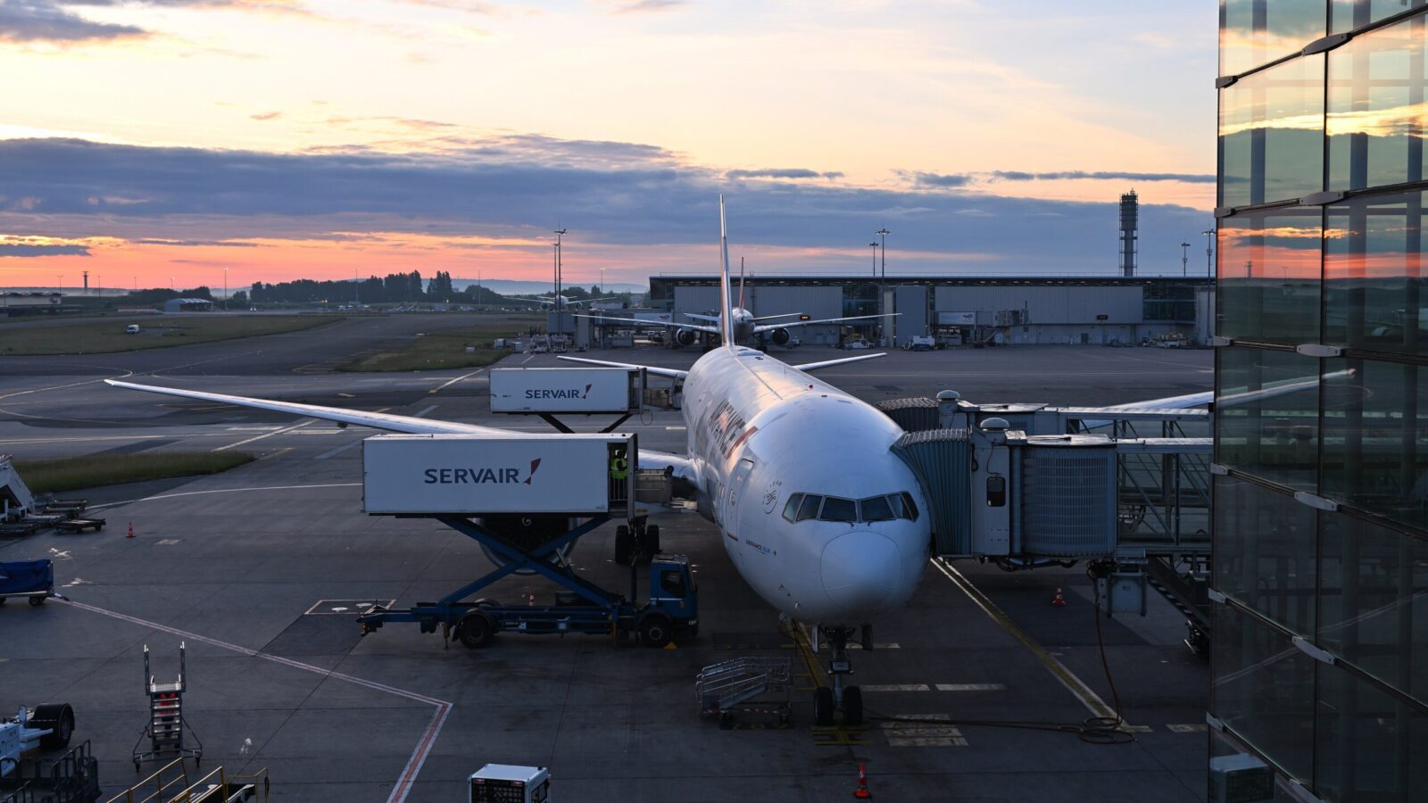 Aircraft at Paris Charles de Gaulle Terminal 2 at sunset
