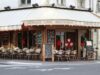 Who Protects Paris’s Identity When Tolerance Is Exploited by Extremism? Historic Paris corner café beneath Haussmann architecture