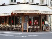 Who Protects Paris’s Identity When Tolerance Is Exploited by Extremism? Historic Paris corner café beneath Haussmann architecture