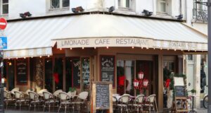 Who Protects Paris’s Identity When Tolerance Is Exploited by Extremism? Historic Paris corner café beneath Haussmann architecture