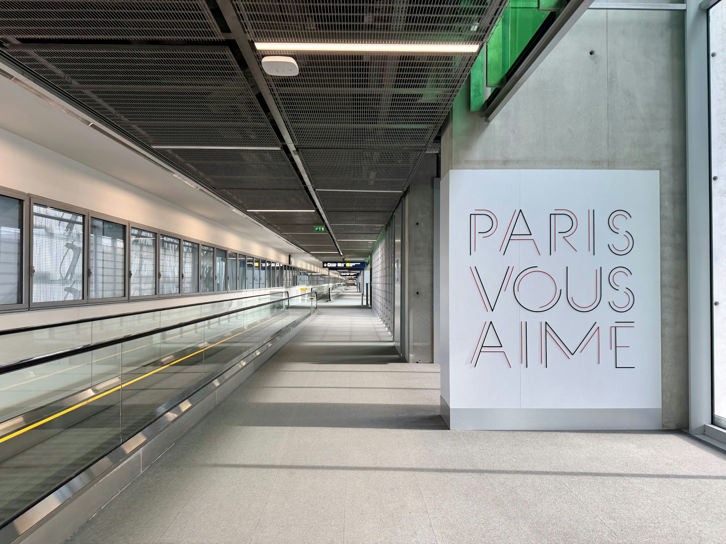 Modern Paris Charles de Gaulle airport walkway with Paris vous aime artwork
