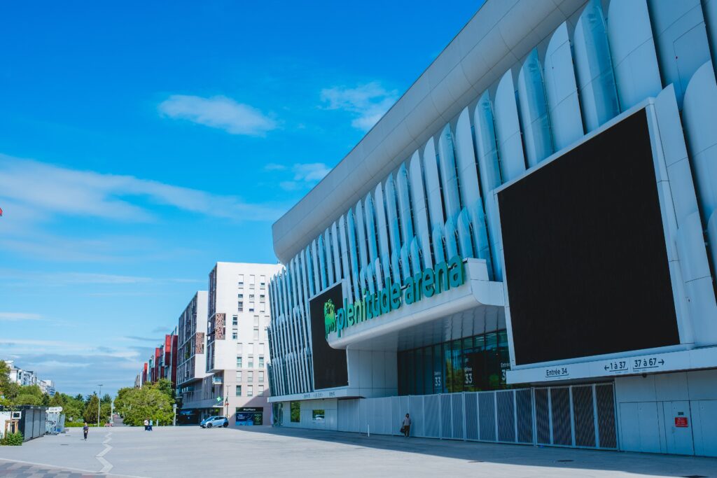 New Plenitude Arena signage on the venue façade in Nanterre in July 2026