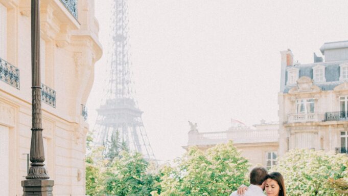 Romantic Paris hotel balcony with Eiffel Tower view Couple on a Paris balcony with an Eiffel Tower view